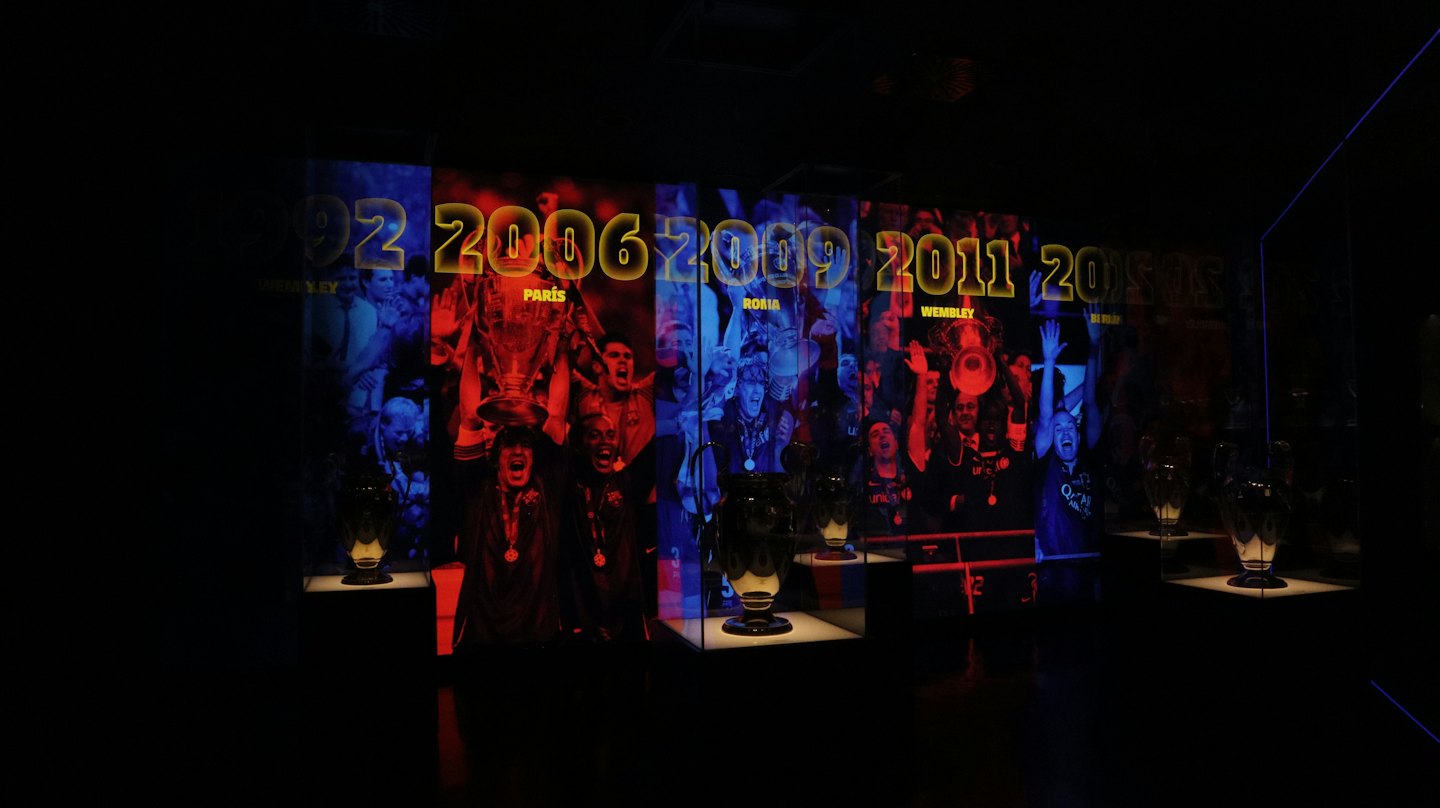 Sports trophies and historical display panels inside a museum exhibition.